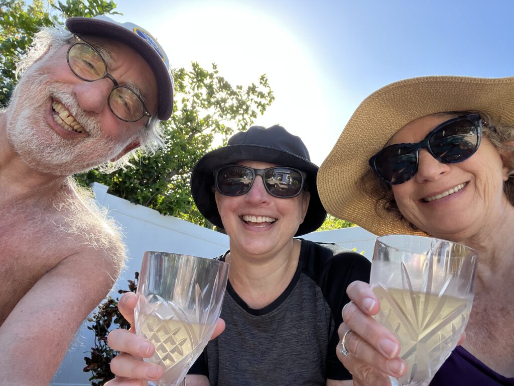 Dad, me, and mom in a row with wine glasses